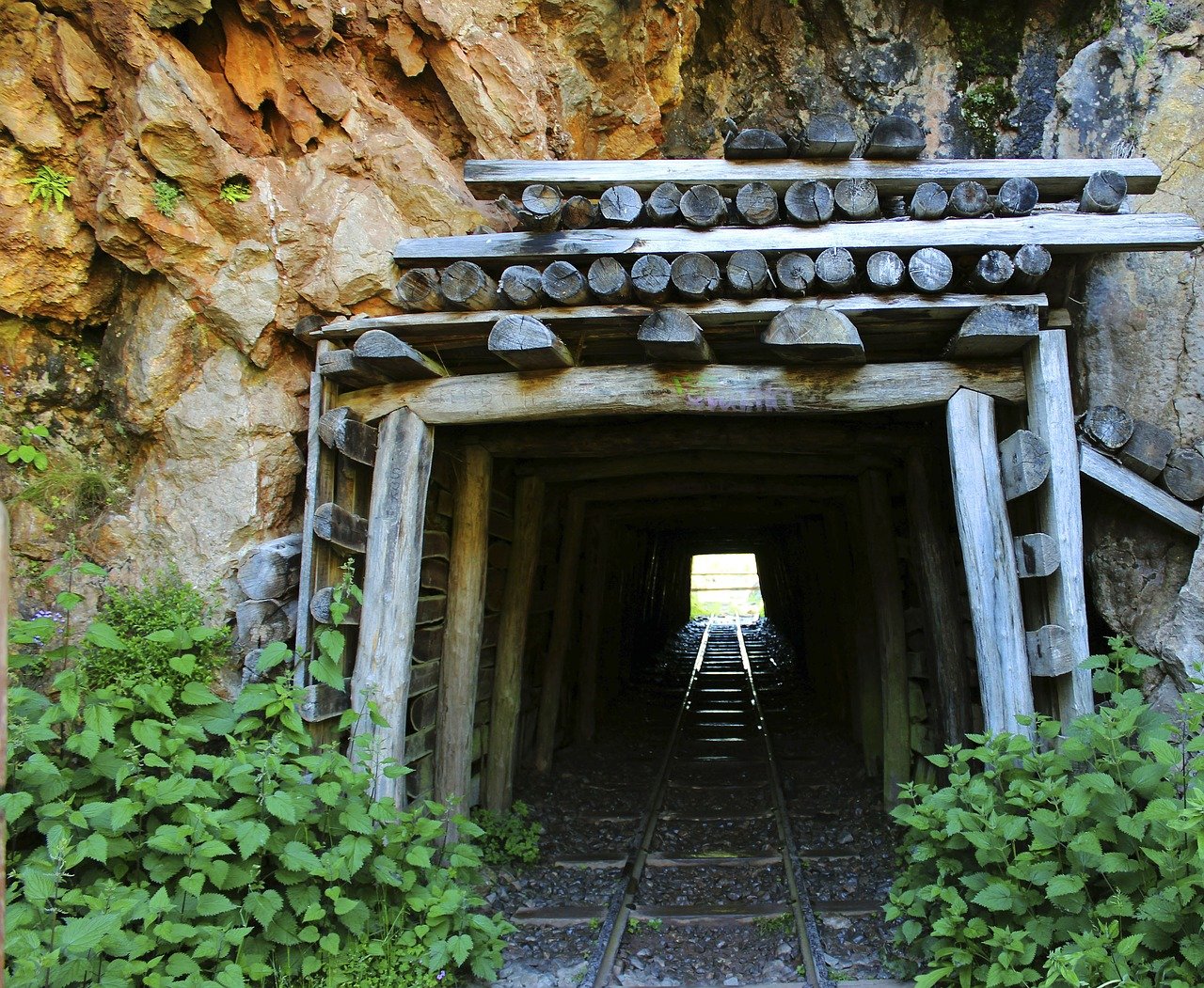 coal mine with light at the end of the tunnel