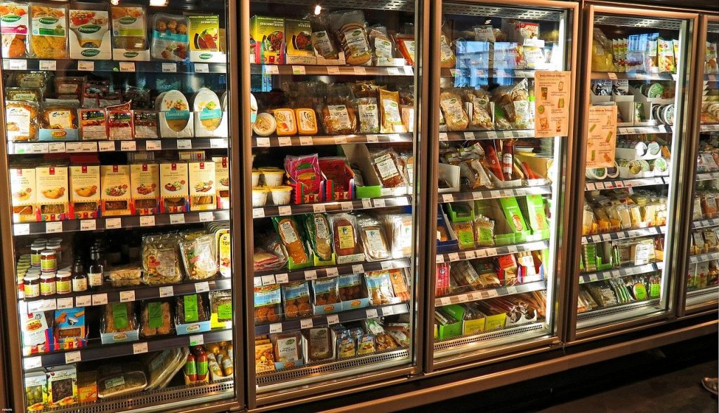 supermarket fridge with cheese and deli meats