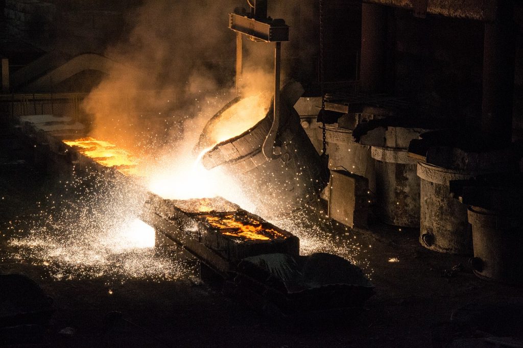 hot liquid metal being poured into molds