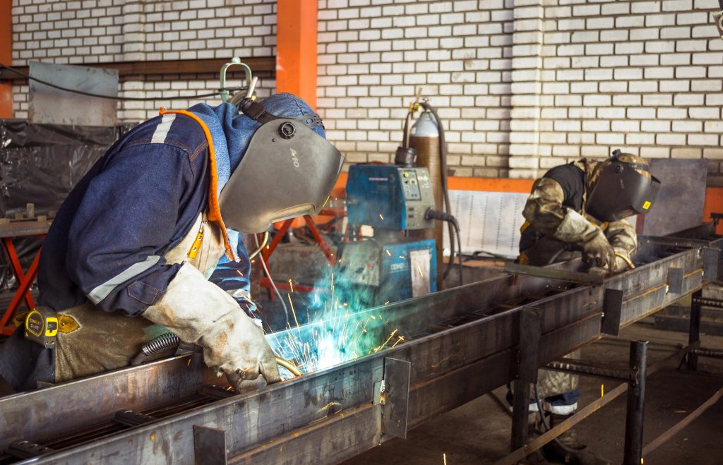 two men oxy welding metal