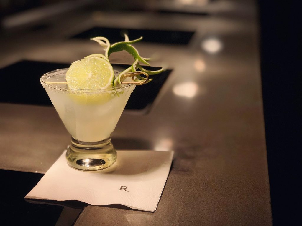 a lemon cocktail with a salted rim and garnish