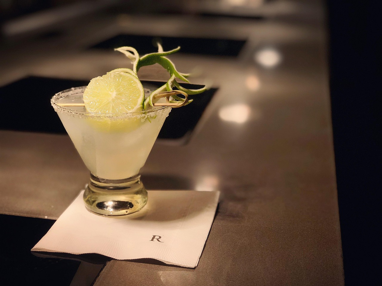 a lemon cocktail with a salted rim and garnish